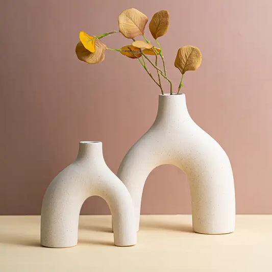 Pair of elegant white ceramic vases, perfect for decorating your modern spaces.