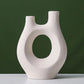 Abstract Hollow Ceramic Vase for Stylish Home and Office Decor.